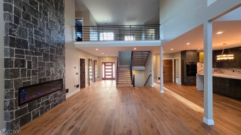 27 Sanders Road Rockaway, NJ 07866 - Photo 3 of 16 a view of a hallway with wooden floor and a fireplace