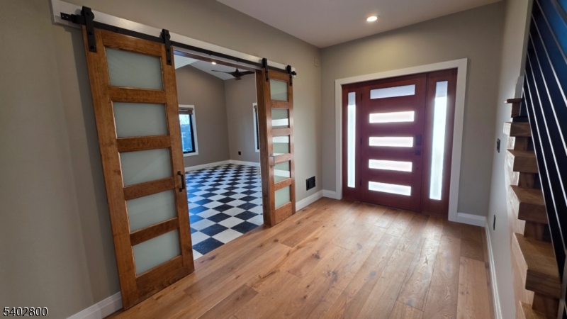 27 Sanders Road Rockaway, NJ 07866 - Photo 4 of 16 wooden floor in an empty room with a window
