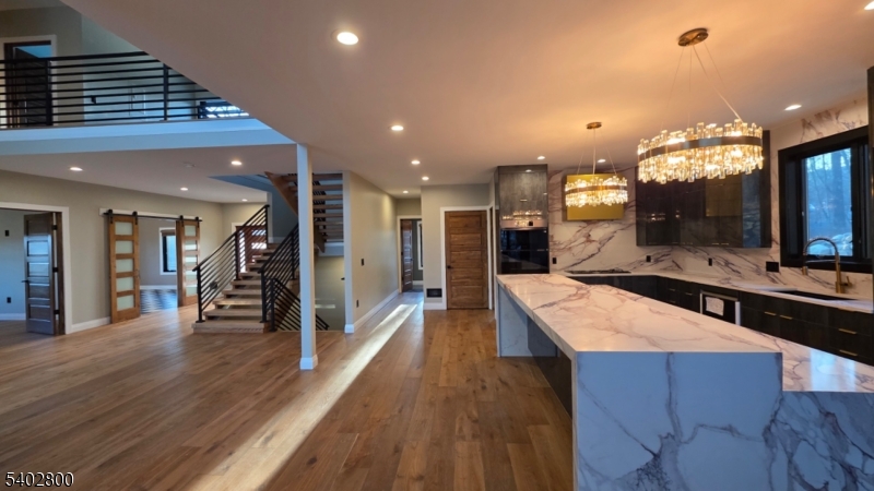 27 Sanders Road Rockaway, NJ 07866 - Photo 6 of 16 a large kitchen with stainless steel appliances a large counter top and a stove