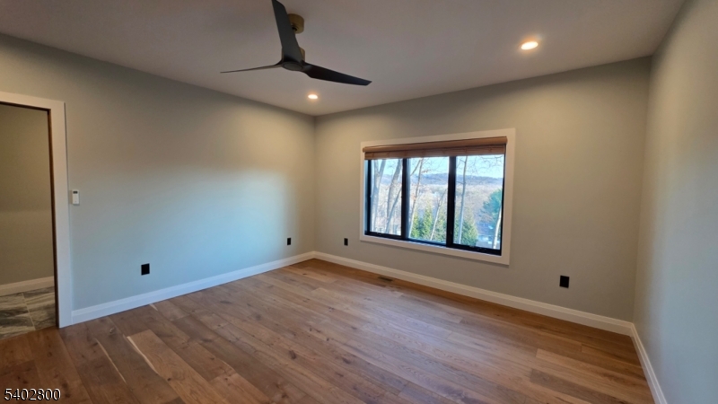 27 Sanders Road Rockaway, NJ 07866 - Photo 7 of 16 an empty room with wooden floor and windows
