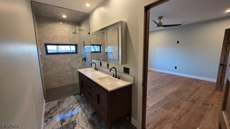 27 Sanders Road Rockaway, NJ 07866 - Photo 8 of 16 a bathroom with a sink and a mirror