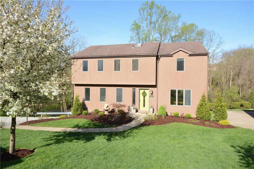 a front view of a house with a yard table and chairs