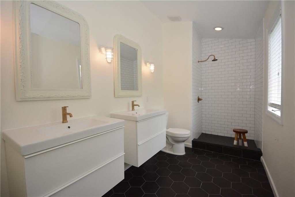 1222 Driftwood Drive Mt. Lebanon, PA 15243 - Photo 18 of 25 a bathroom with a double vanity sink toilet and a mirror