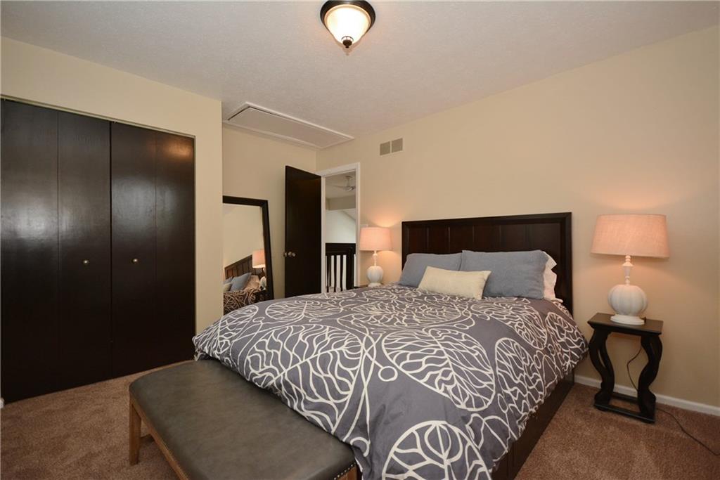 1222 Driftwood Drive Mt. Lebanon, PA 15243 - Photo 19 of 25 a bedroom with a bed and lamp