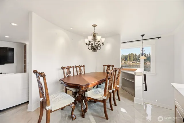 a dining room with furniture a chandelier and window