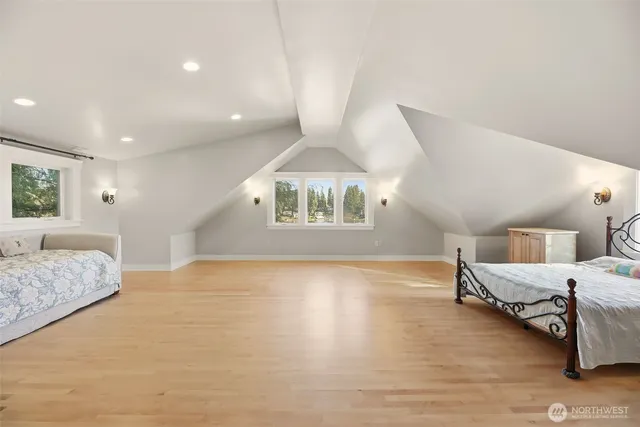 a spacious bedroom with a bed and a large window