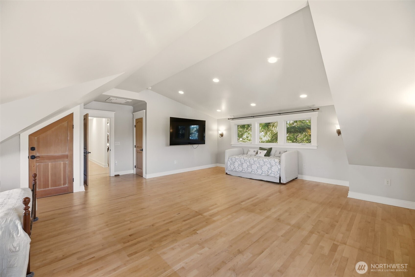 3821 Shelby Road Lynnwood, WA 98087 - Photo 18 of 40 a view of an empty room with wooden floor and a kitchen