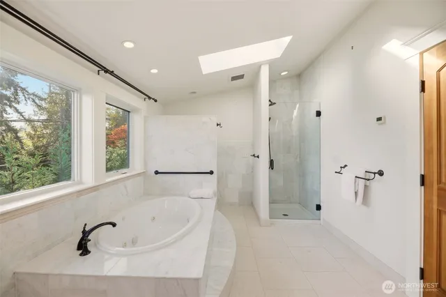 a bathroom with a bathtub and a shower