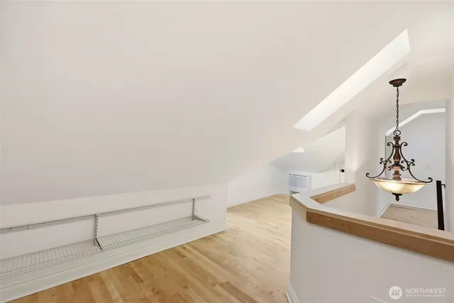 a view of a sink and dishwasher with wooden floor