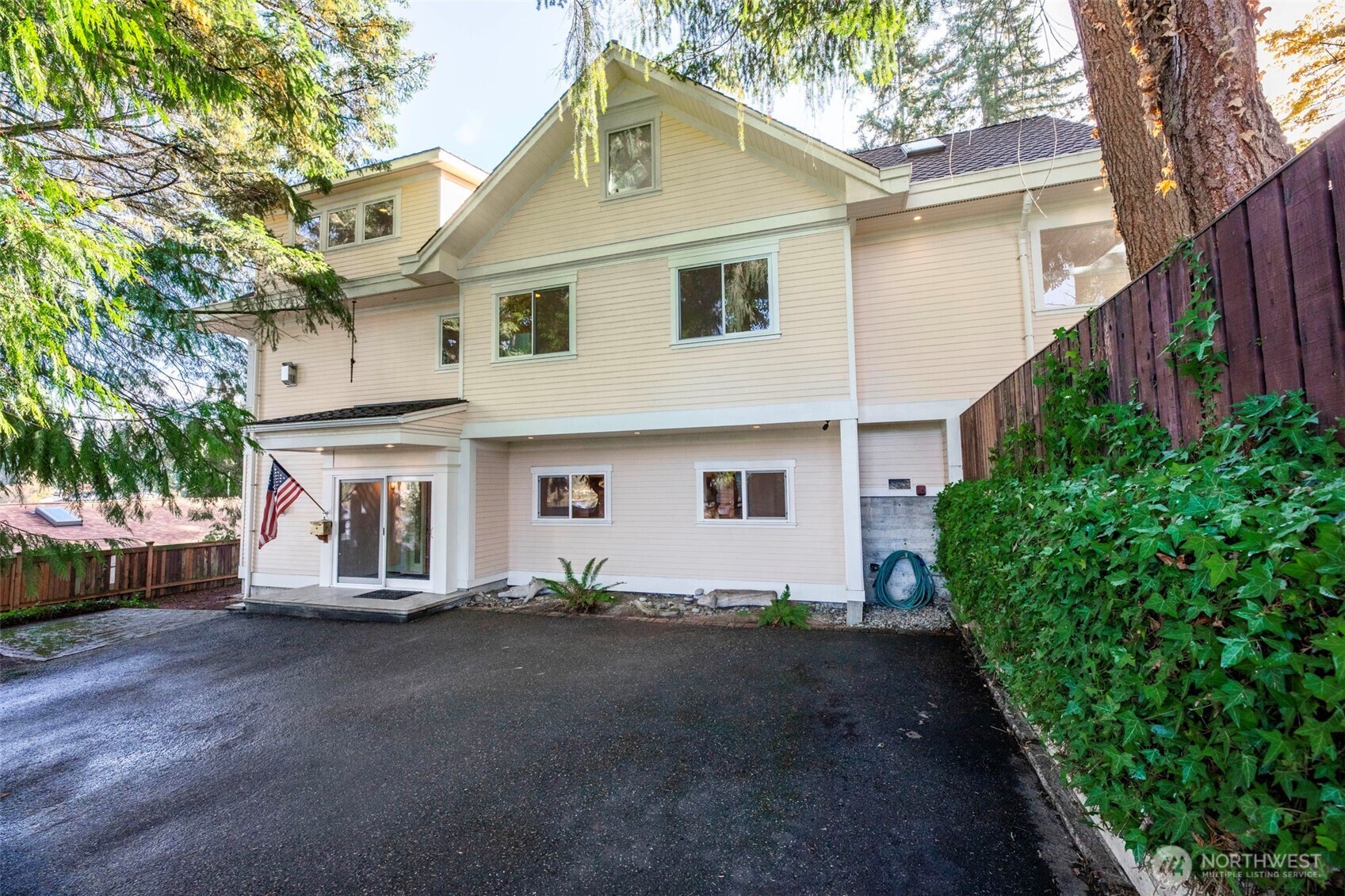 3821 Shelby Road Lynnwood, WA 98087 - Photo 36 of 40 a view of a white house with a small yard and large tree