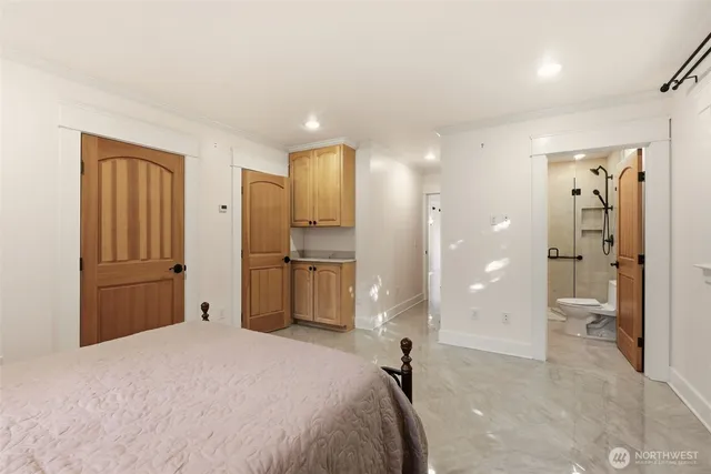 a bedroom with a bed and a bathroom