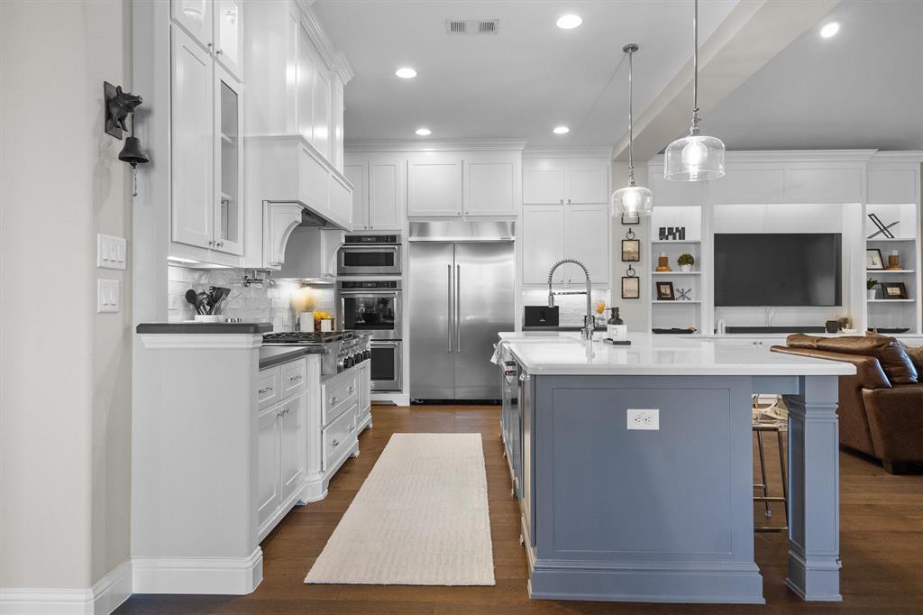 11459 Misty Ridge Drive Flower Mound, TX 76262 - Photo 13 of 38 a kitchen with kitchen island a sink stainless steel appliances and cabinets