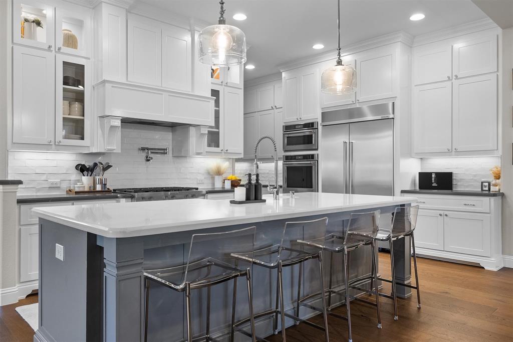 11459 Misty Ridge Drive Flower Mound, TX 76262 - Photo 14 of 38 a kitchen with kitchen island granite countertop a sink a center island stainless steel appliances and cabinets