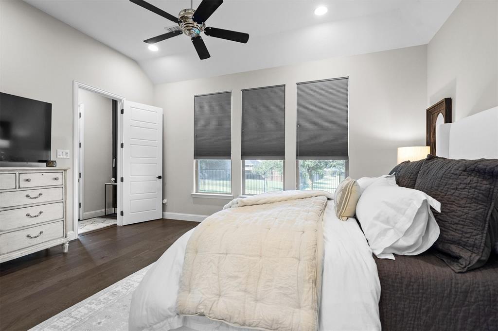 11459 Misty Ridge Drive Flower Mound, TX 76262 - Photo 22 of 38 a bedroom with a bed and a flat screen tv