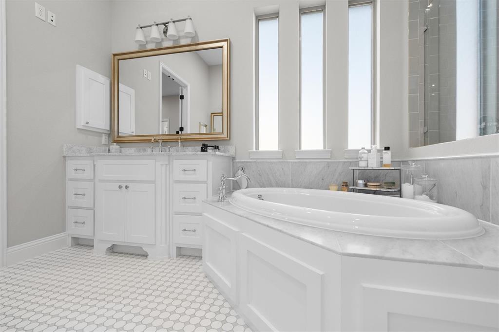 11459 Misty Ridge Drive Flower Mound, TX 76262 - Photo 25 of 38 a bathroom with a sink vanity and a mirror