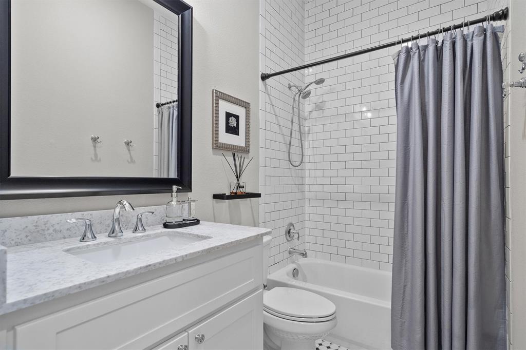 11459 Misty Ridge Drive Flower Mound, TX 76262 - Photo 27 of 38 a bathroom with a granite countertop sink toilet and shower