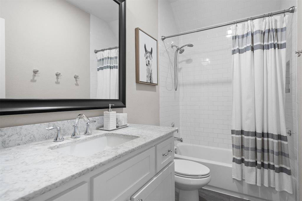 11459 Misty Ridge Drive Flower Mound, TX 76262 - Photo 29 of 38 a bathroom with a granite countertop sink toilet and shower