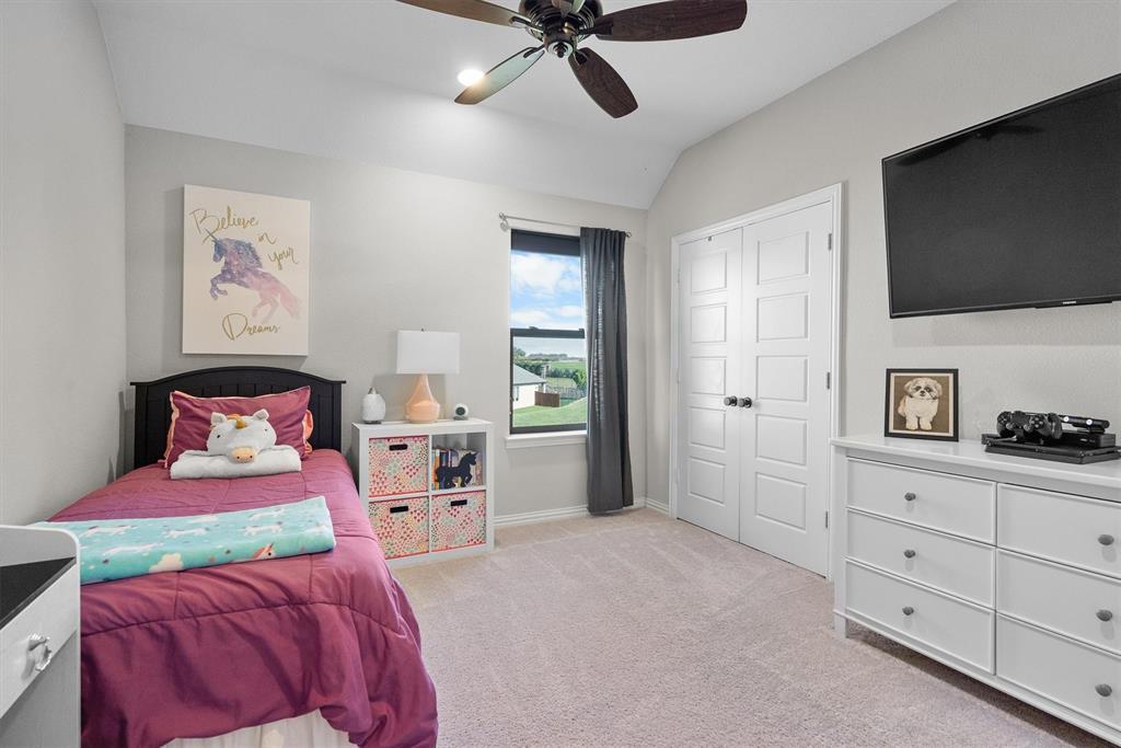 11459 Misty Ridge Drive Flower Mound, TX 76262 - Photo 30 of 38 a bedroom with a bed and a flat screen tv