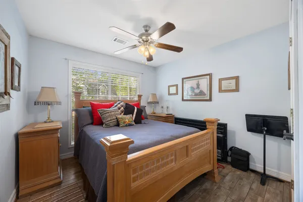 a living room with lots of furniture and ceiling fan