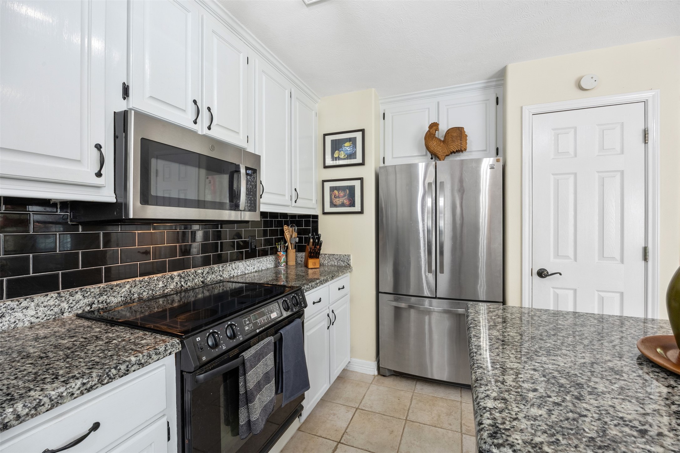 80 Indian Harbor Trinity, TX 75862 - Photo 23 of 47 a kitchen with granite countertop a refrigerator stove and microwave