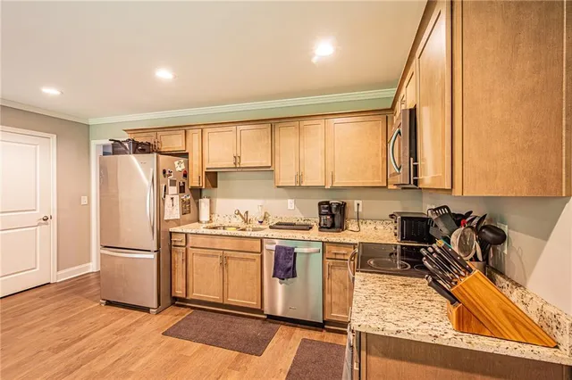 a kitchen with a refrigerator a stove a sink and a microwave