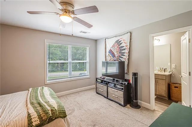 a bedroom with furniture and a window