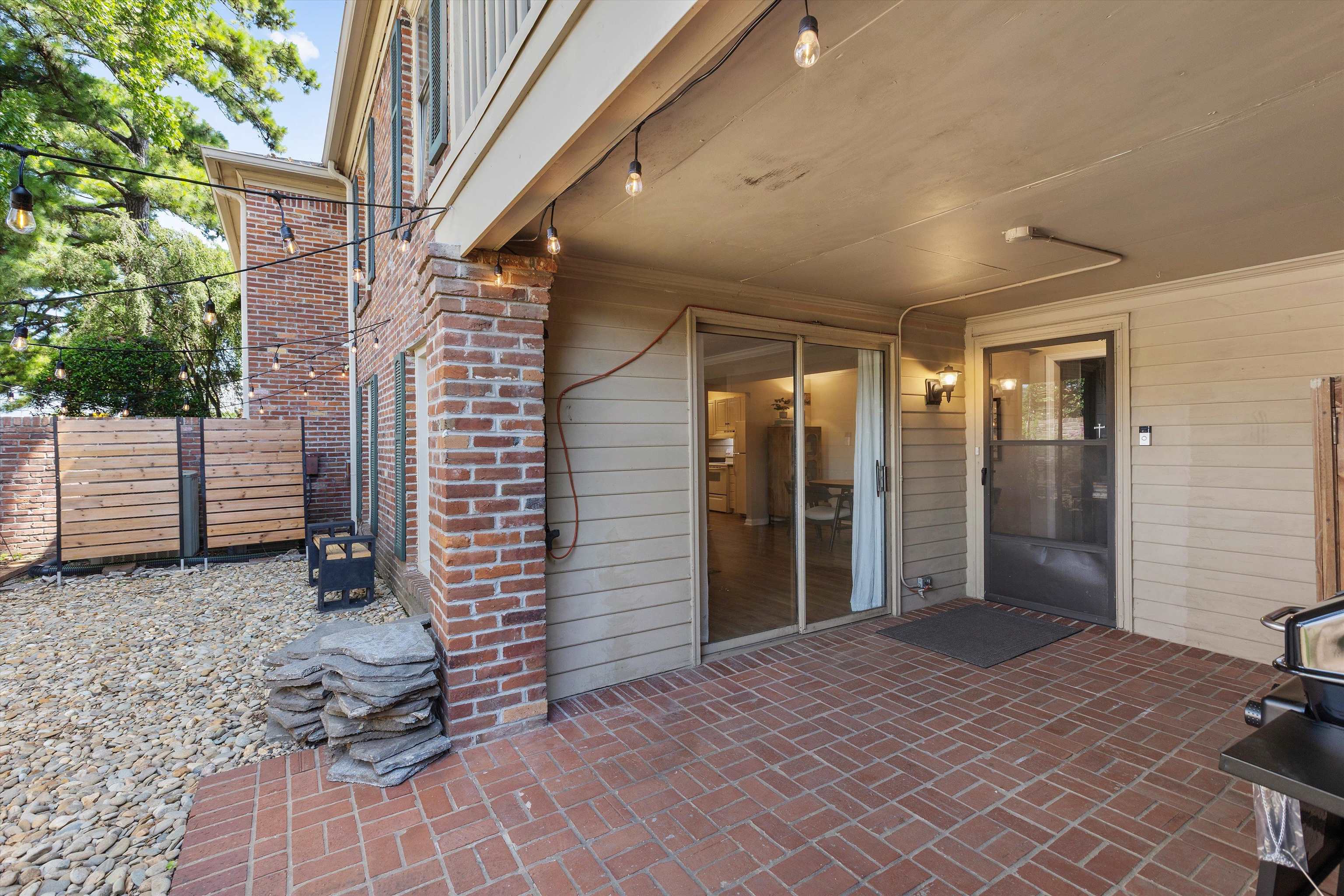 1184 Lynnfield Road, Unit 1 Memphis, TN 38119 - Photo 4 of 28 Enjoy the covered porch for rainy days and relax or entertain in the private patio with new hardscape and new wood screens that give a clean view while keeping AC units accessible.