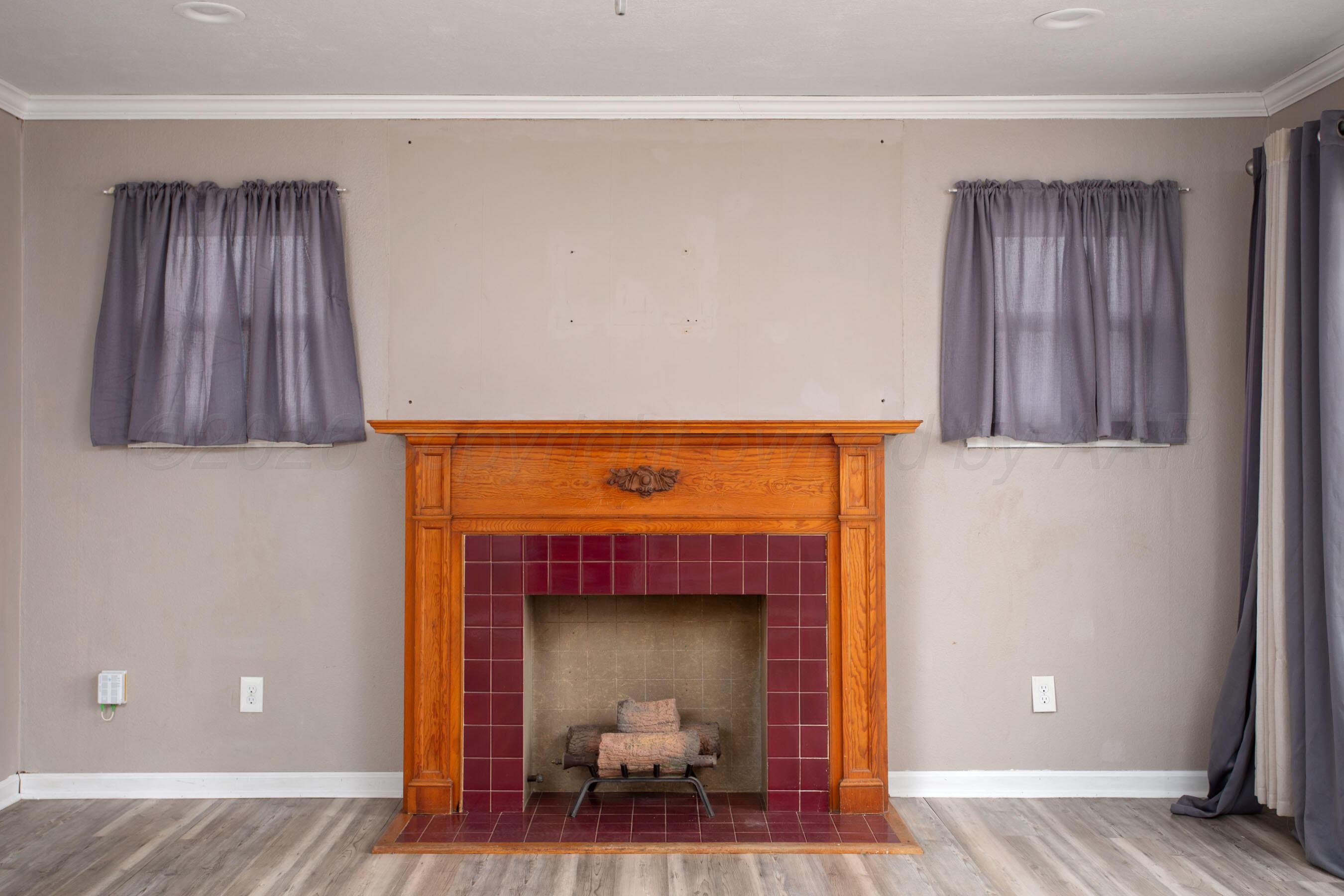a hallway with a fireplace and a wooden floor