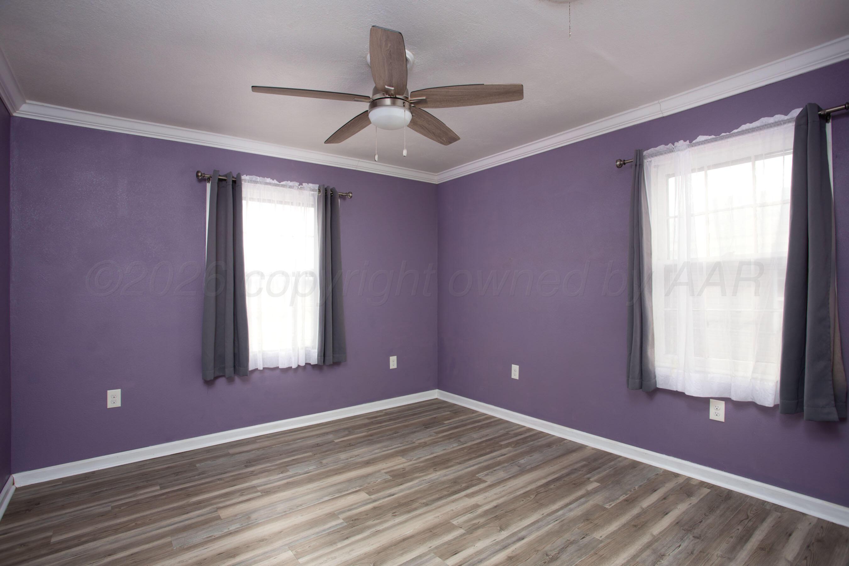 1616 South Travis Street Amarillo, TX 79102 - Photo 15 of 26 a view of empty room with wooden floor and fan