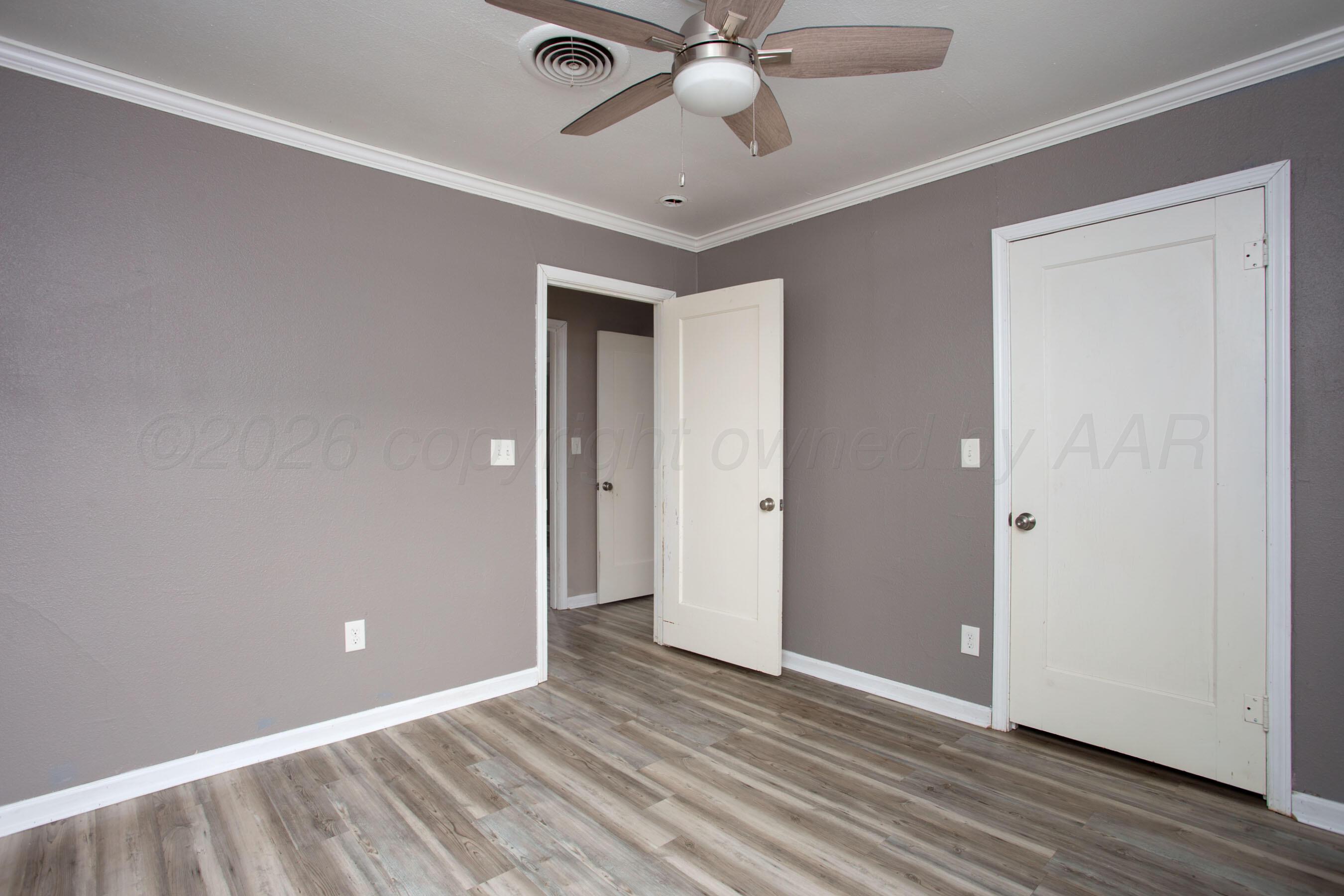 1616 South Travis Street Amarillo, TX 79102 - Photo 16 of 26 a view of an empty room and wooden floor