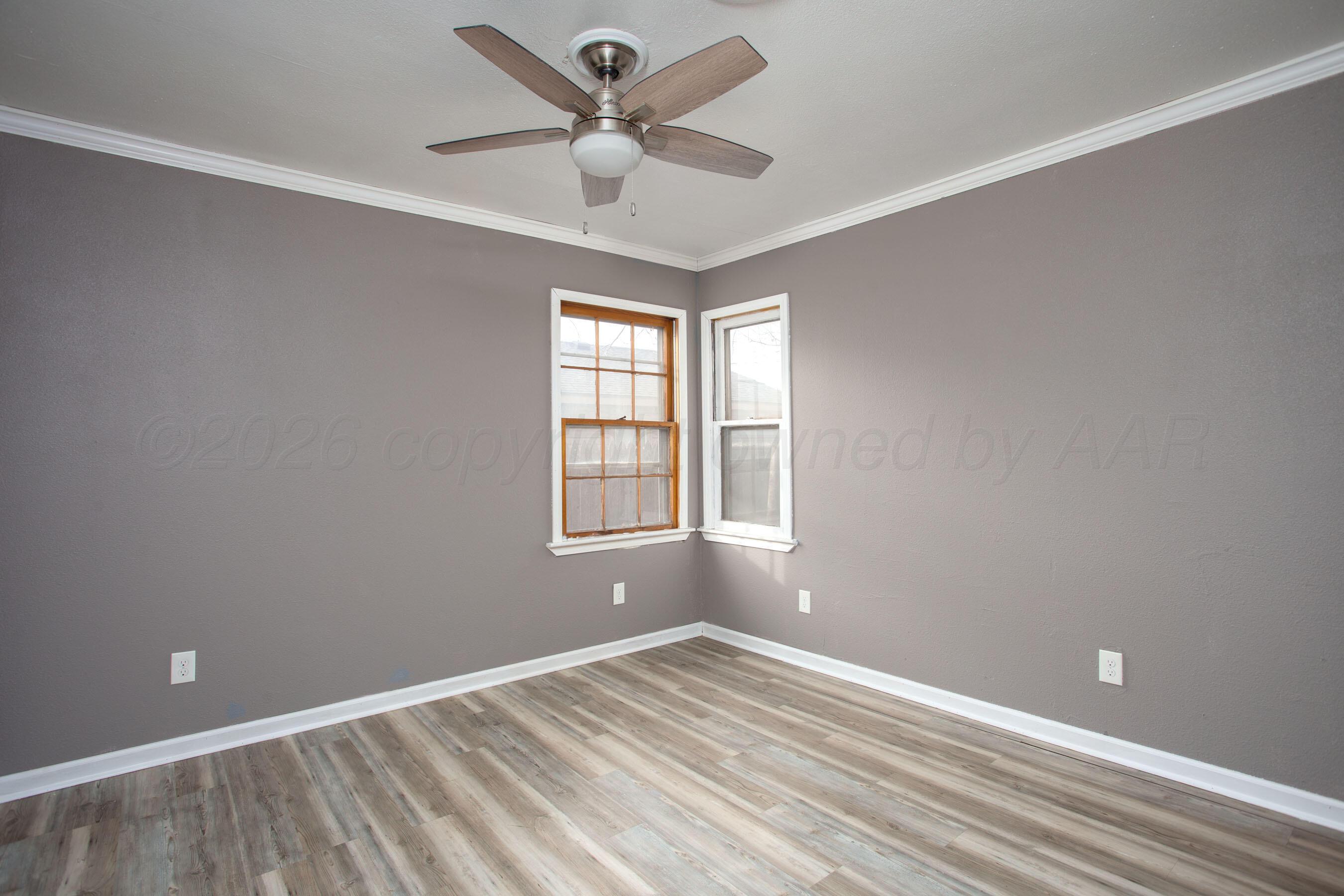 1616 South Travis Street Amarillo, TX 79102 - Photo 17 of 26 an empty room with a window and a fan