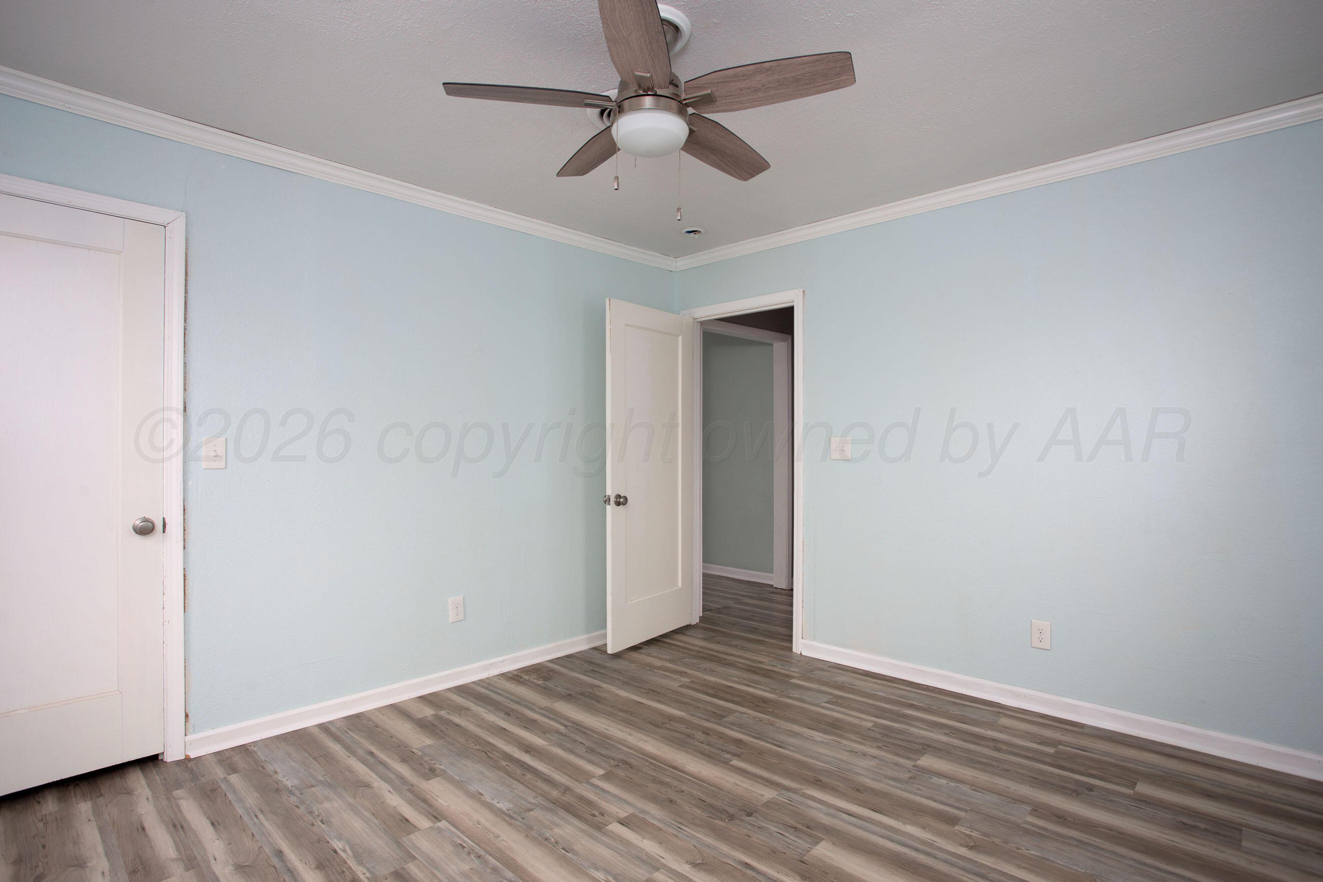 1616 South Travis Street Amarillo, TX 79102 - Photo 19 of 26 wooden floor in an empty room