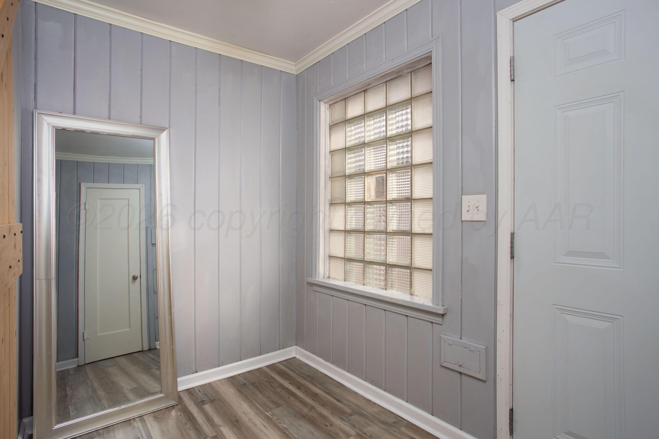1616 South Travis Street Amarillo, TX 79102 - Photo 5 of 26 a view of empty room with wooden floor and closet