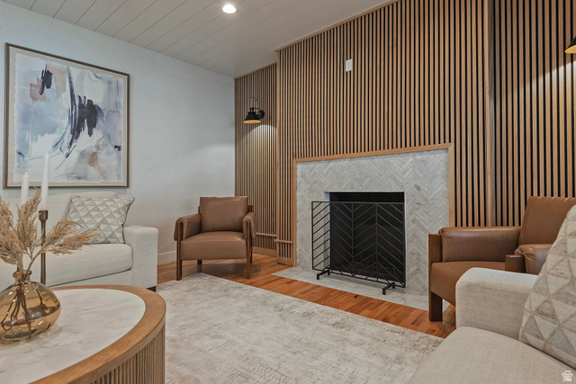 16 Gatehouse Lane Sandy, UT 84092 - Photo 18 of 73 Living room with wood floors, a fireplace, recessed lighting, and wood accent walls