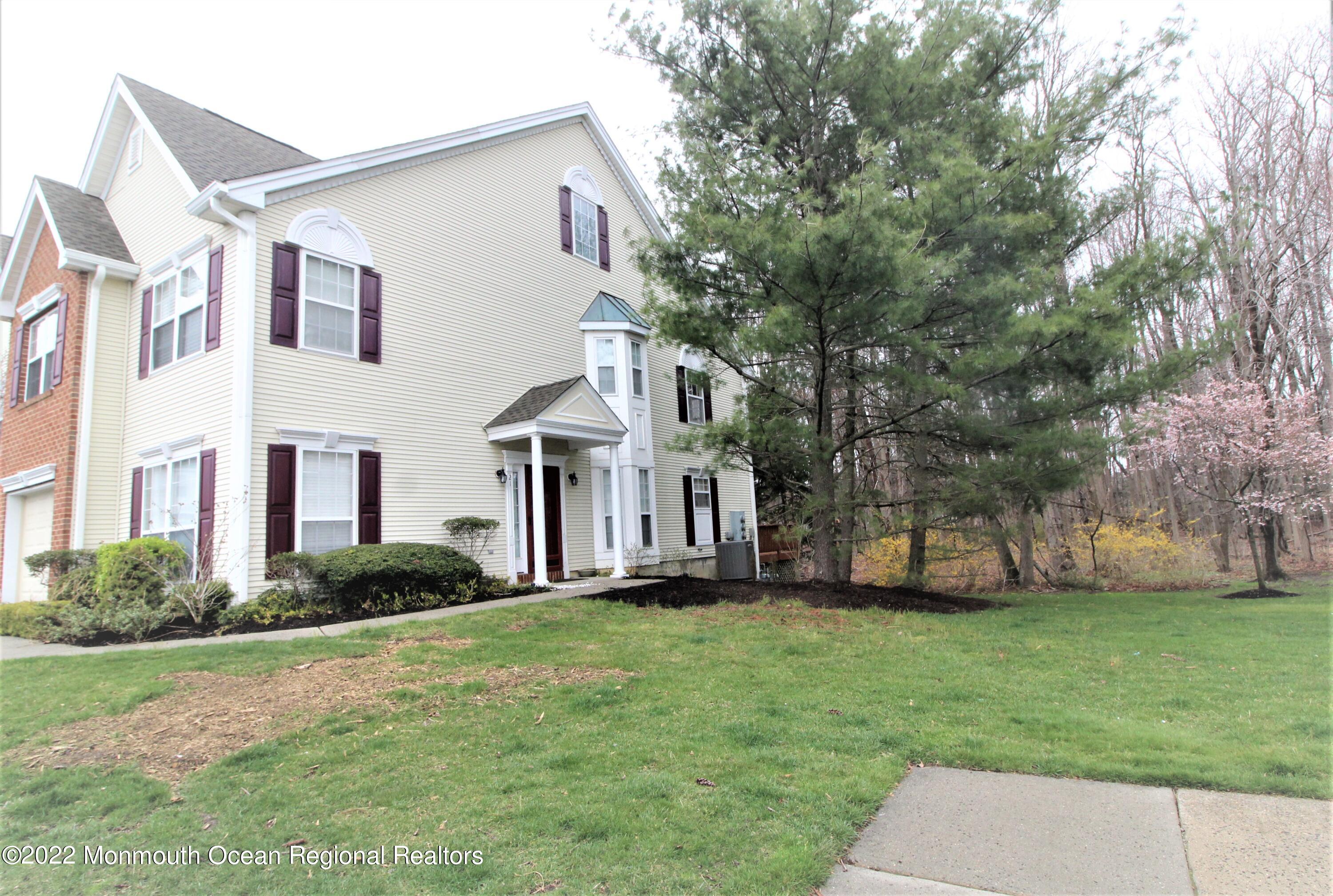 21 Durant Avenue, Unit 145 Holmdel, NJ 07733 - Photo 1 of 25 a front view of a house with a yard and trees