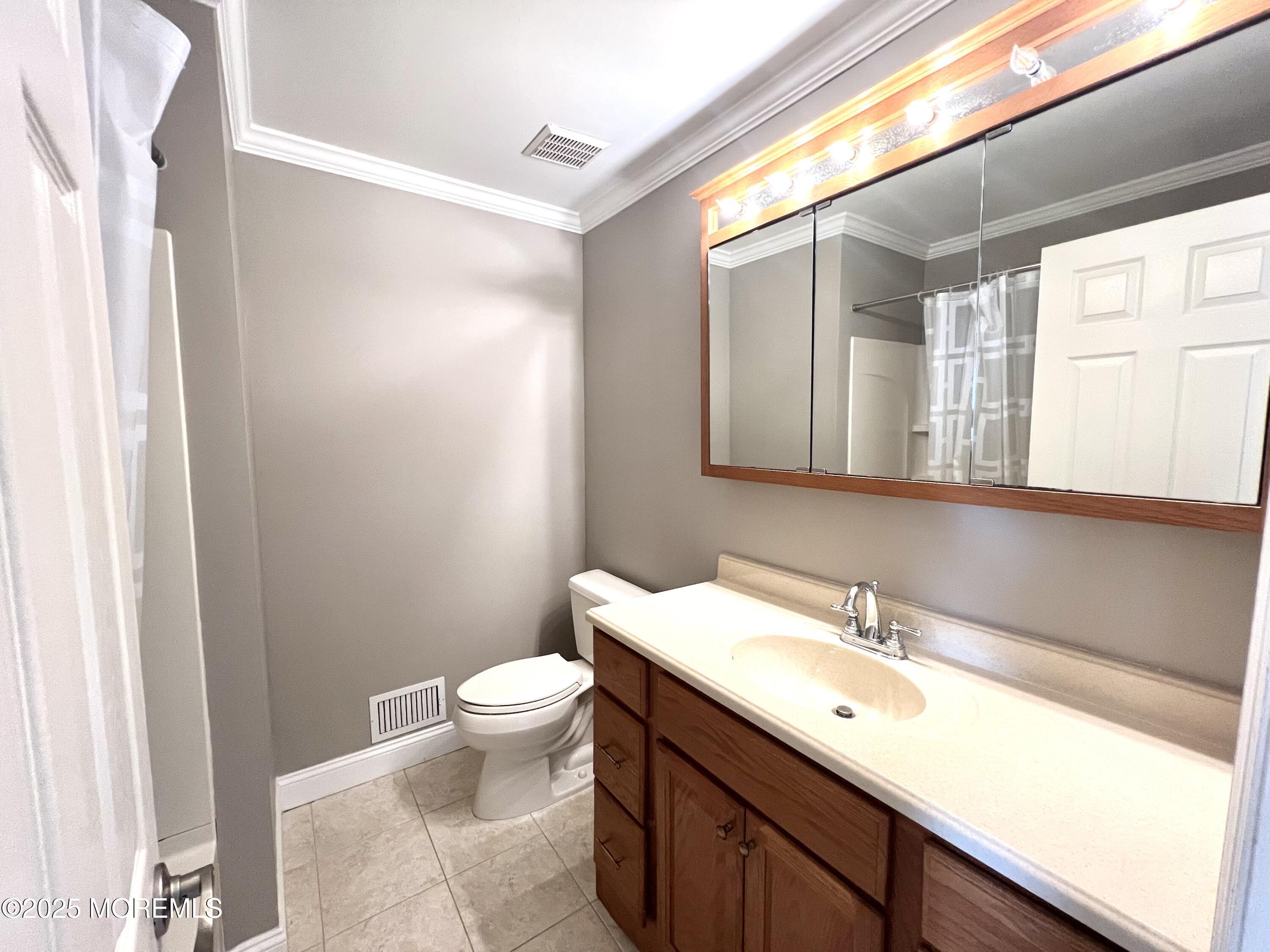 21 Durant Avenue, Unit 145 Holmdel, NJ 07733 - Photo 19 of 25 a bathroom with a sink and a mirror