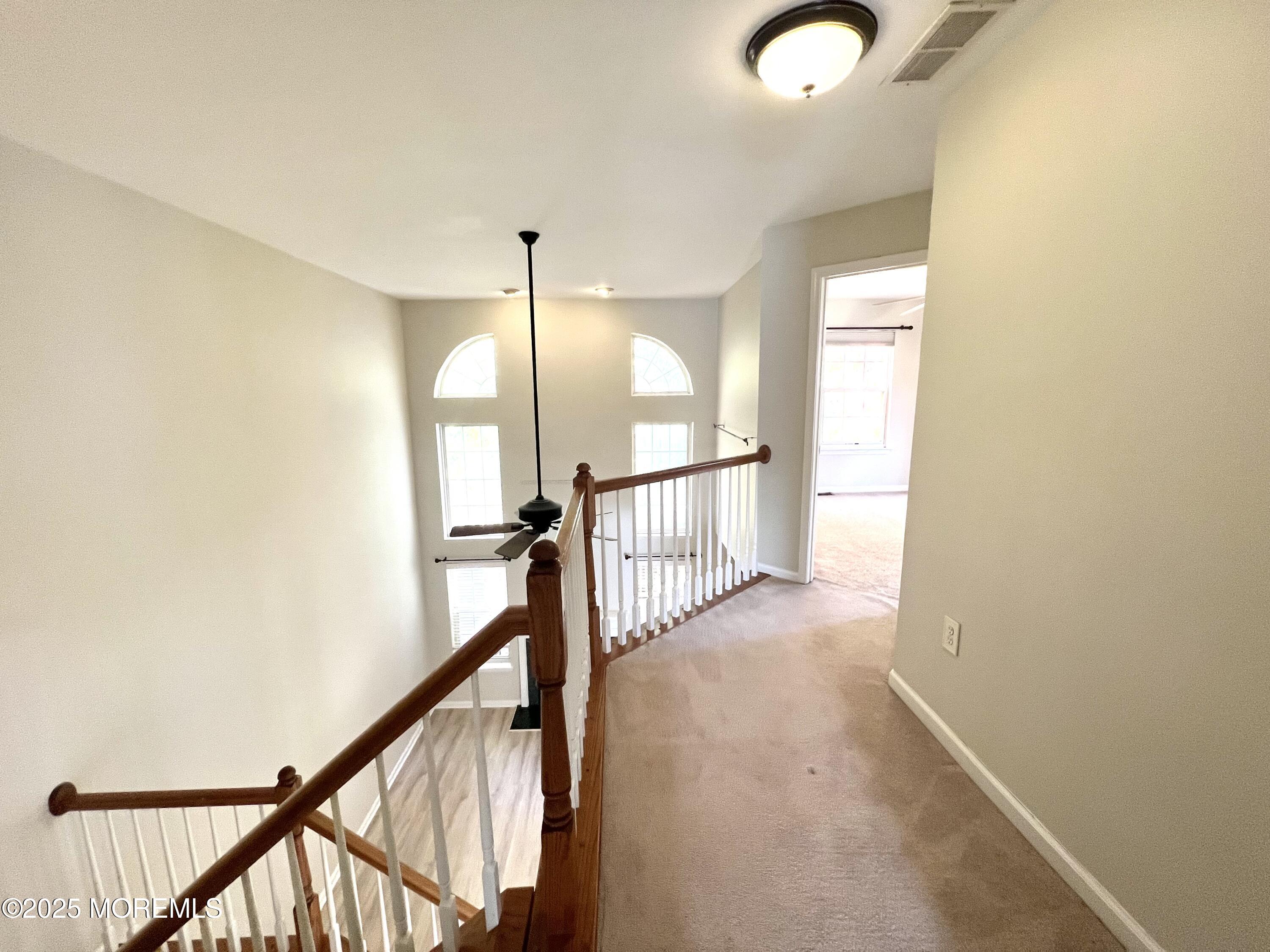 21 Durant Avenue, Unit 145 Holmdel, NJ 07733 - Photo 20 of 25 a view of a hallway with wooden floor and staircase