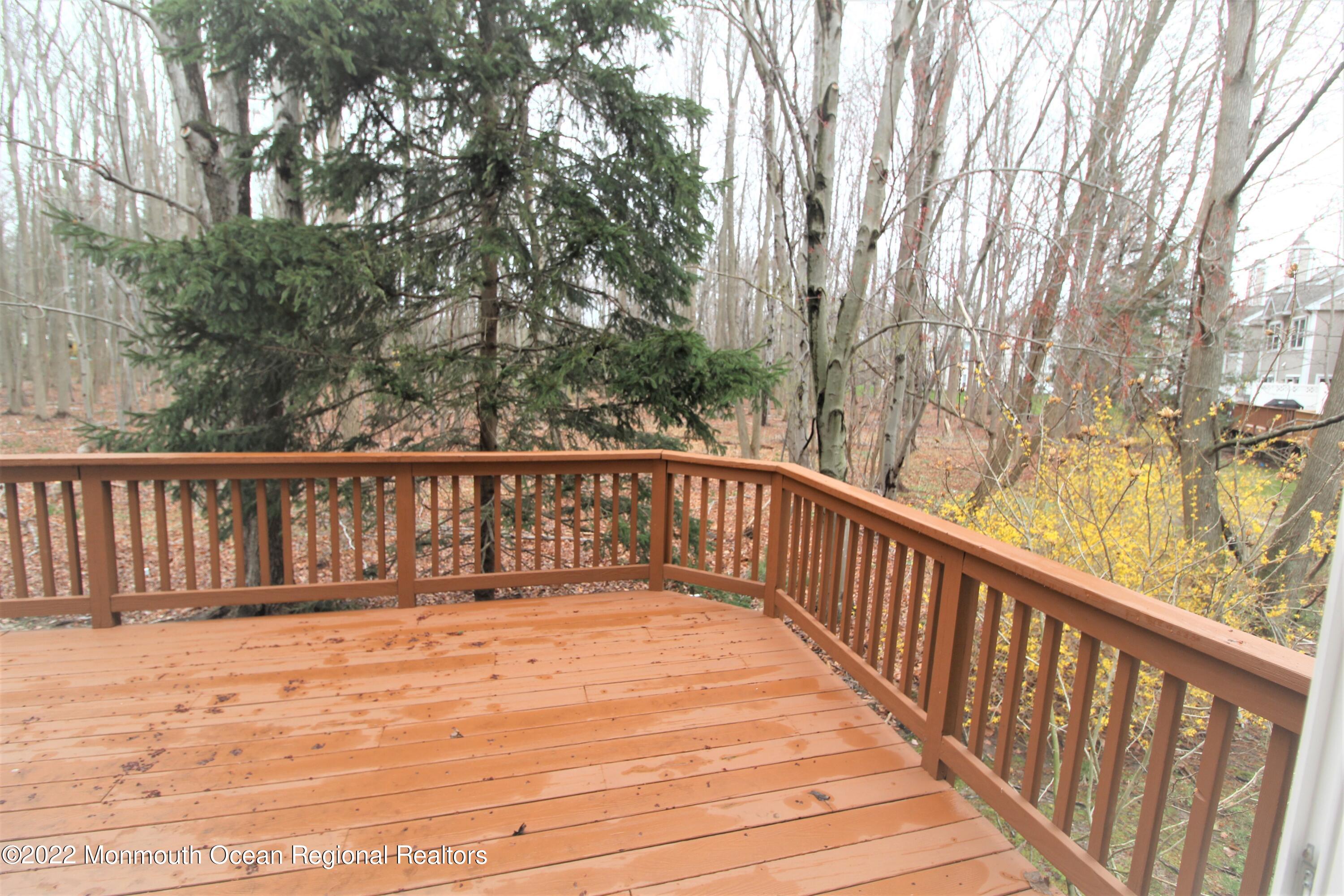 21 Durant Avenue, Unit 145 Holmdel, NJ 07733 - Photo 25 of 25 a view of balcony with wooden floor and fence