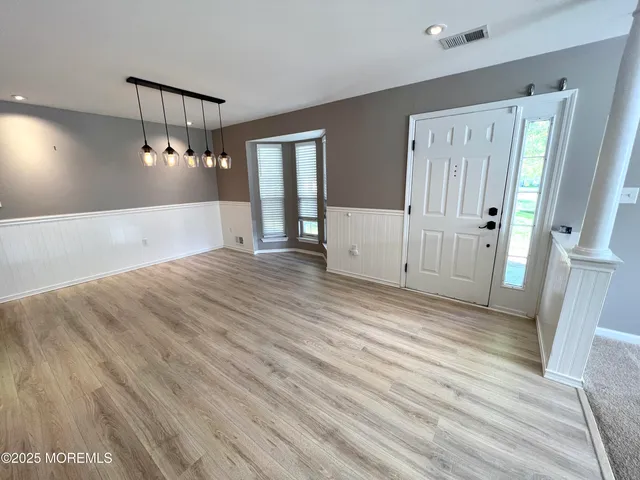 a view of a room with wooden floor and staircase