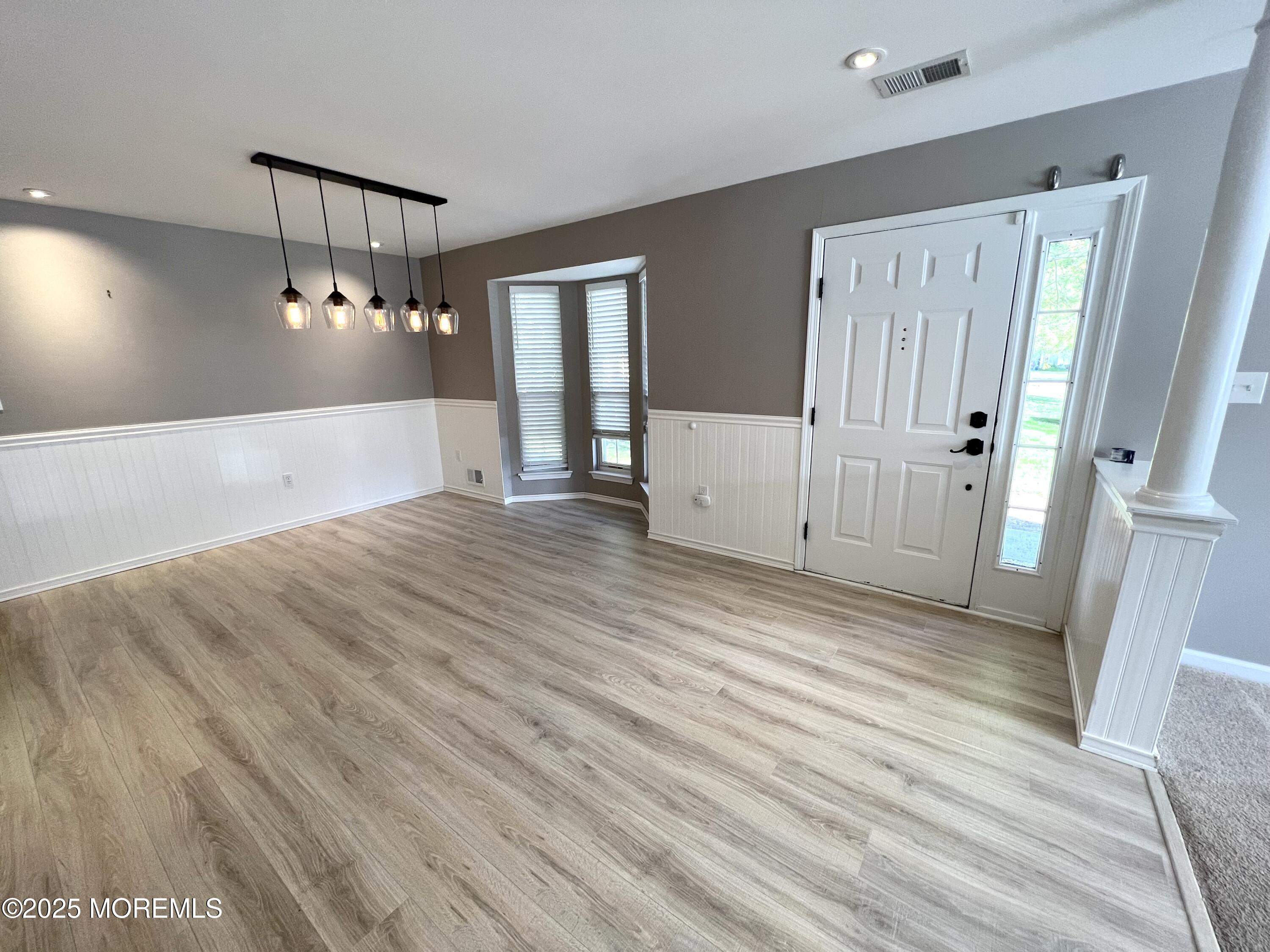 21 Durant Avenue, Unit 145 Holmdel, NJ 07733 - Photo 3 of 25 a view of a room with wooden floor and staircase