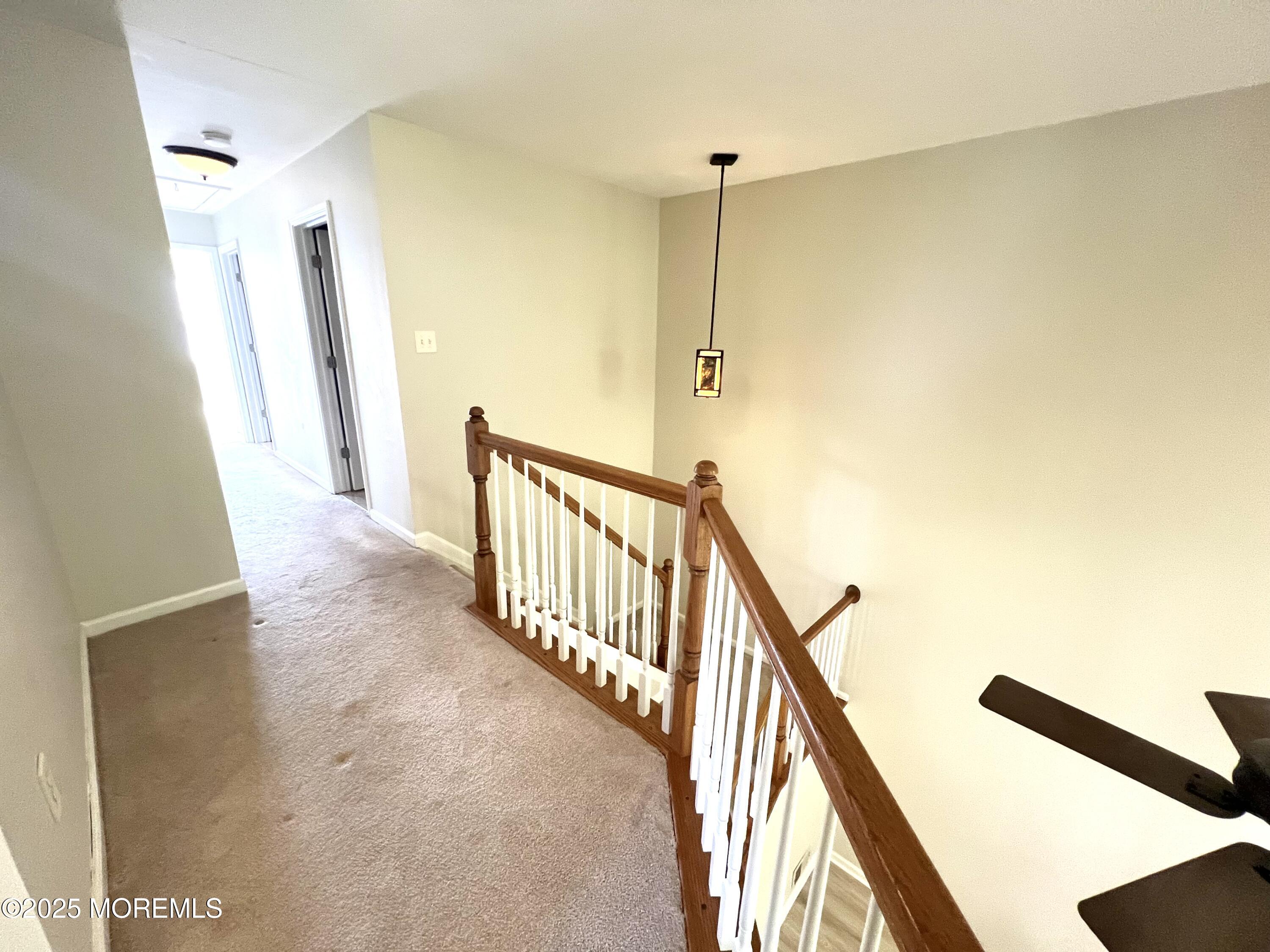 21 Durant Avenue, Unit 145 Holmdel, NJ 07733 - Photo 9 of 25 a view of a hallway with stairs