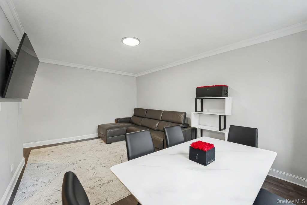 141-35 78th Road, Unit 2M Queens, NY 11367 - Photo 2 of 11 a kitchen with a stove a microwave and a counter top space