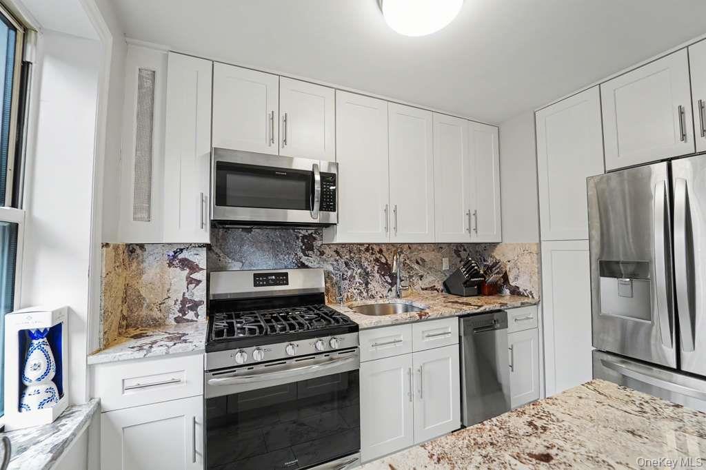 141-35 78th Road, Unit 2M Queens, NY 11367 - Photo 6 of 11 a kitchen with a stove and a refrigerator