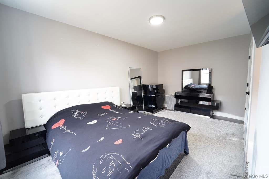 141-35 78th Road, Unit 2M Queens, NY 11367 - Photo 9 of 11 a bedroom with a bed and a dresser