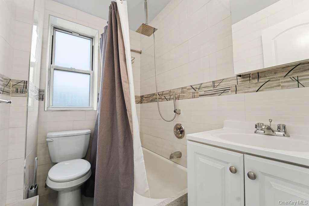 141-35 78th Road, Unit 2M Queens, NY 11367 - Photo 10 of 11 a bathroom with a toilet sink and shower