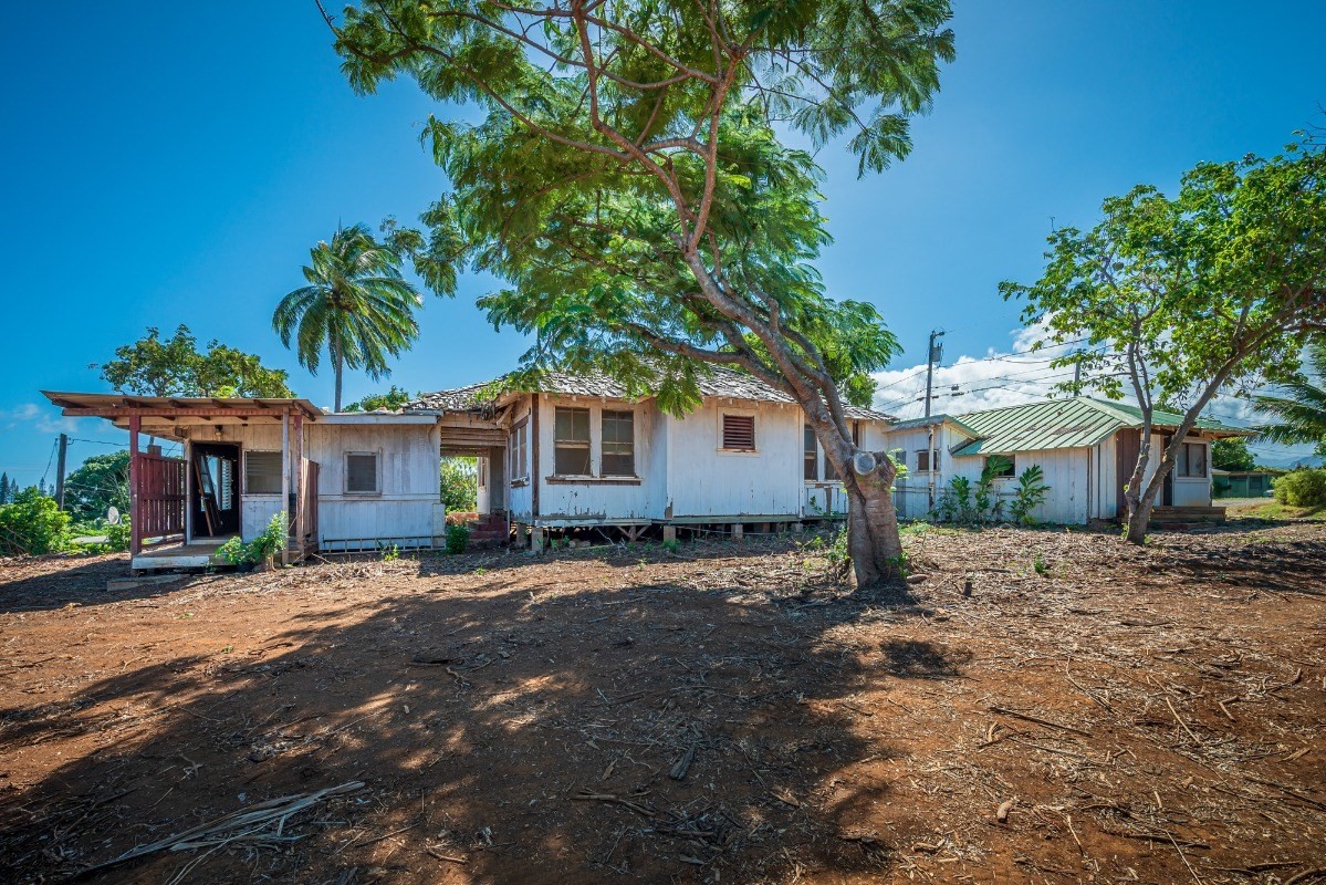 4964 La Road Kapaa, HI 96746 - Photo 9 of 18 a front view of a house with a dirt yard and a large tree