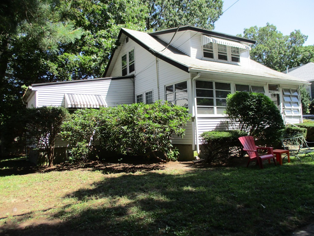 15 Edgewood Road Newton, MA 02465 - Photo 3 of 14 a view of a white house with a yard and plants