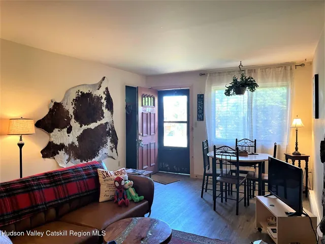 a living room with furniture fireplace and wooden floor