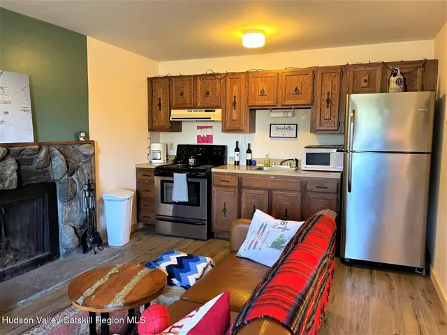 a kitchen with stainless steel appliances a stove a refrigerator and a sink