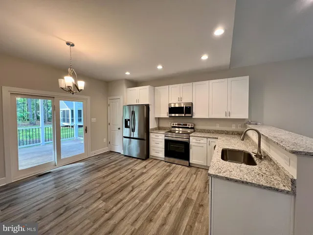 a view of an empty room and wooden floor